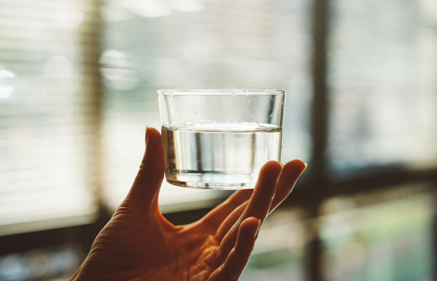 handing hold up glass of water