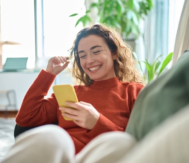 Woman relaxing on sofa smiling