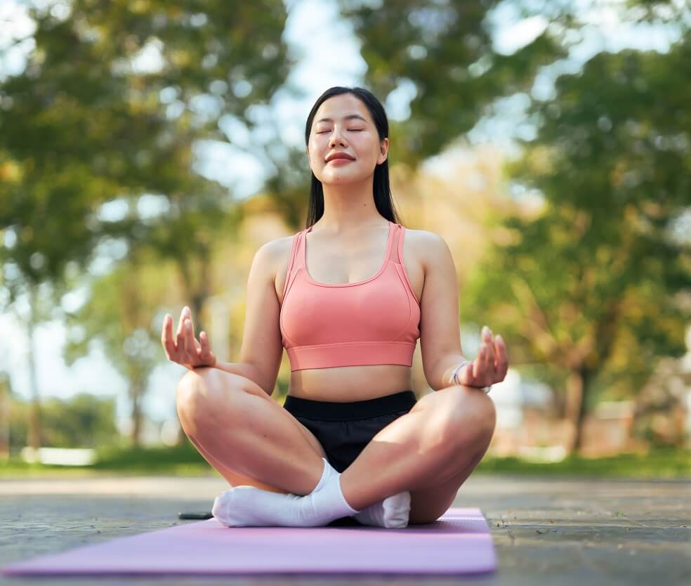 Woman meditating outdoors